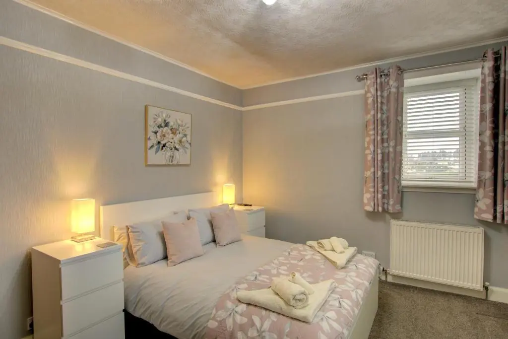 a bedroom with a bed with two lamps on it at The Clachan, Wick in Wick