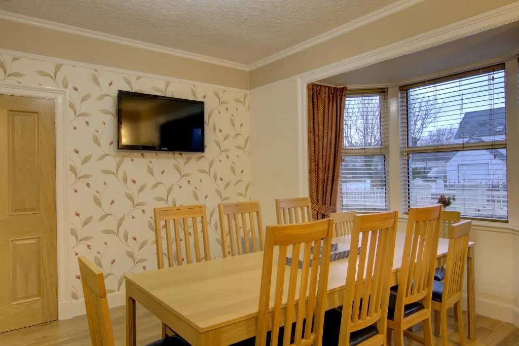 a dining room with a wooden table and chairs at The Clachan, Wick in Wick