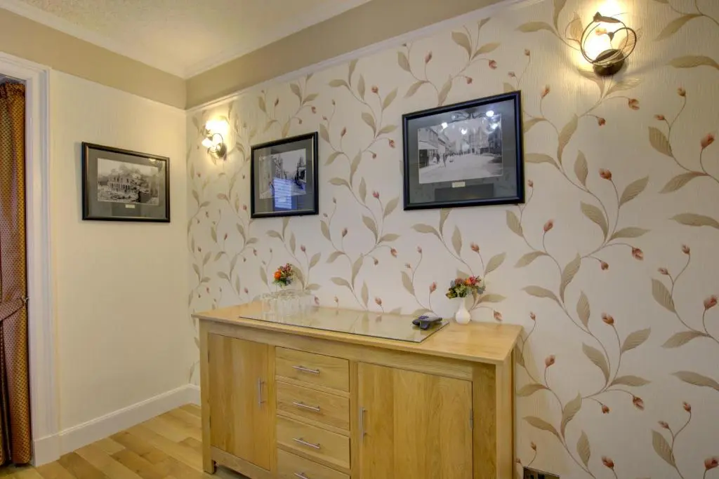 a bathroom with a dresser and a wall at The Clachan, Wick in Wick