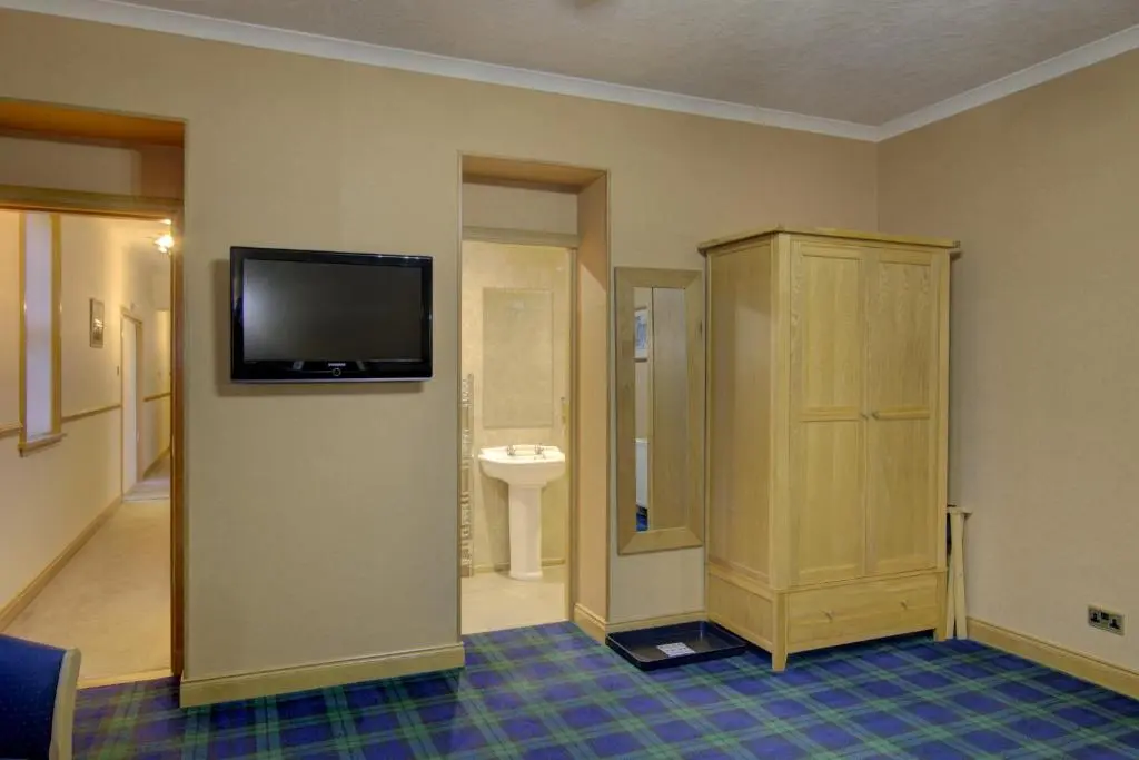 a room with a tv on the wall and a bathroom at The Clachan, Wick in Wick