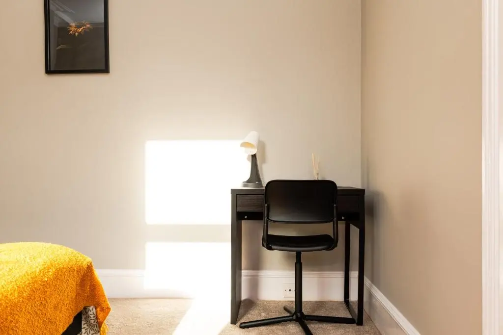 a black chair sitting next to a desk in a room at 2 Bedroom Flat - Free Parking - by Holiday Homes in Inverurie