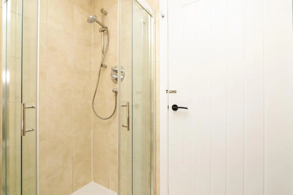 a bathroom with a shower with a glass door at 2 Bedroom Flat - Free Parking - by Holiday Homes in Inverurie