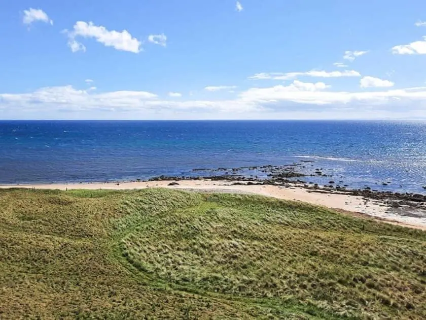 a view of a beach with the ocean at Auld House in Brora