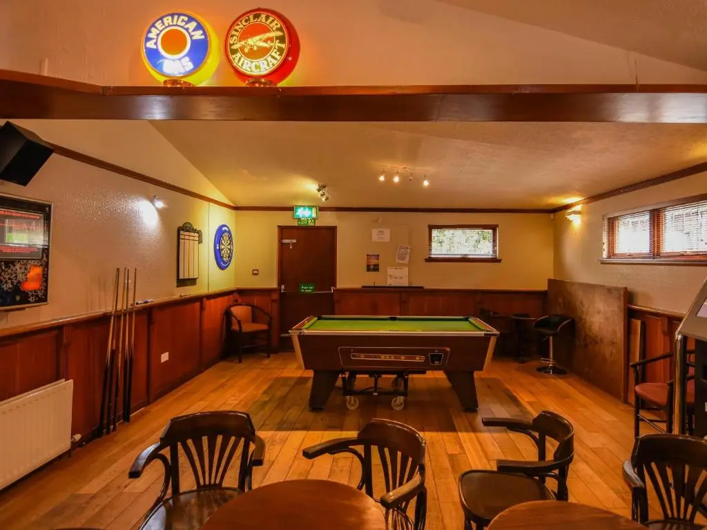 a room with a pool table in the middle of it at Findlay's in Fraserburgh