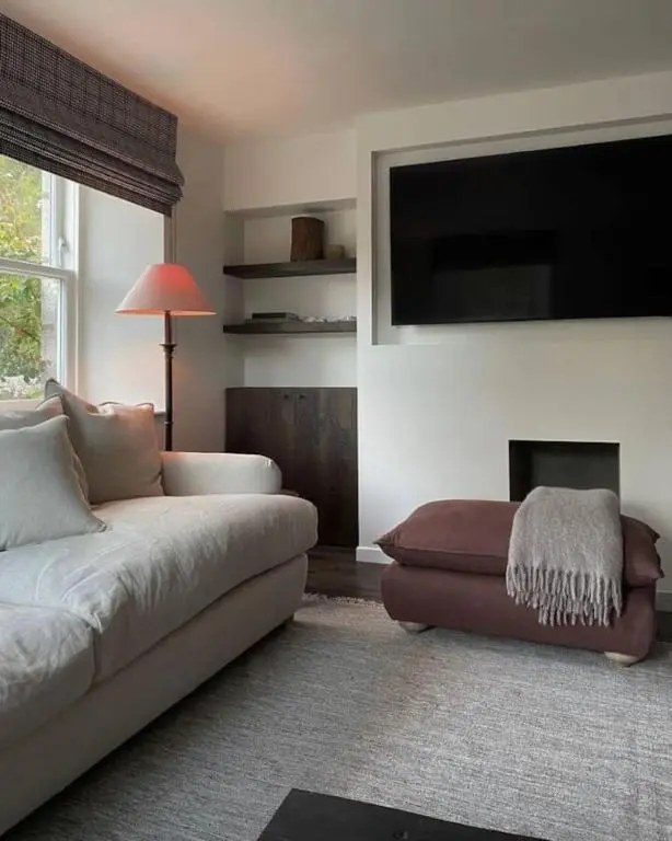 a living room with a couch and a flat screen tv at Old school - Charming Historic Cottage for Seven in Ballater