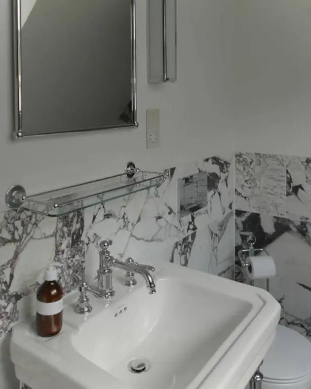 a bathroom with a sink and a mirror and a toilet at Old school - Charming Historic Cottage for Seven in Ballater