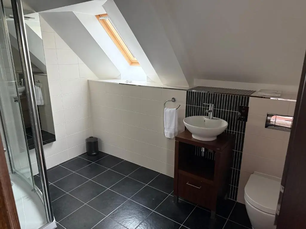 a bathroom with a sink and a shower and a toilet at Castlefield Penthouse in Inverness
