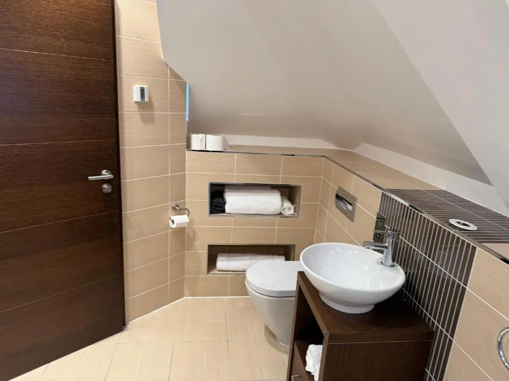 a bathroom with a toilet and a sink at Castlefield Penthouse in Inverness