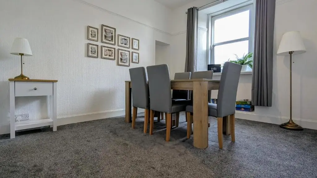 a dining room with a table and chairs at The Wee Heilan' Dram in Keith