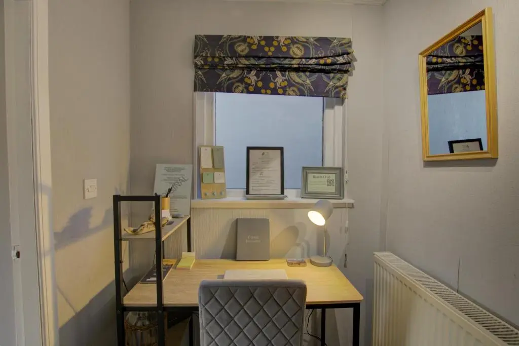 a desk in a room with a window and a chair at Beach Croft, Brora in Brora