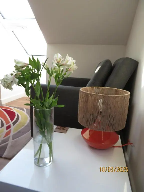 two vases sitting on a table with a couch at The Loft at Log Ness in Inverness