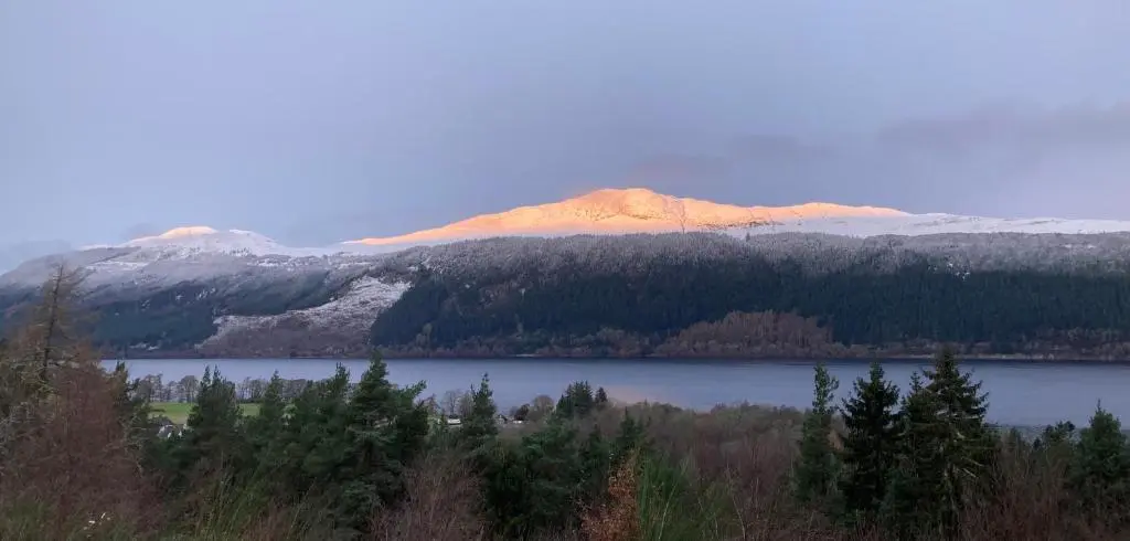 a view of a lake with a mountain in the background at The Loft at Log Ness in Inverness
