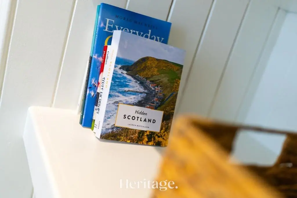 two books are sitting on a shelf at The Copper Loft Apartment, Keith in Keith