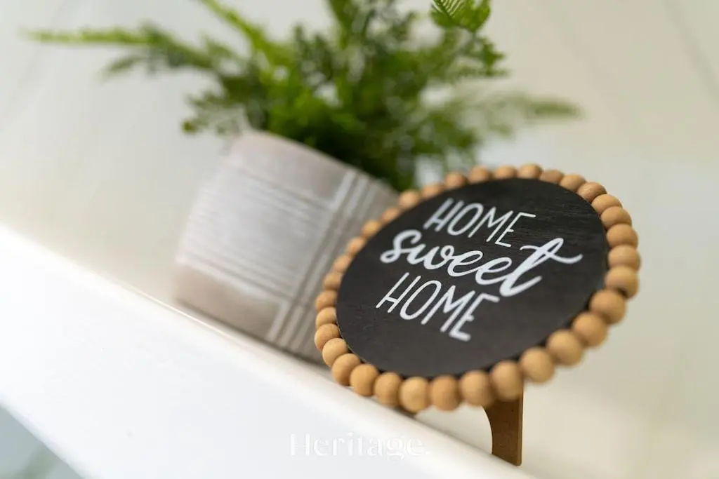 a sign that says have sweet home next to a plant at The Copper Loft Apartment, Keith in Keith