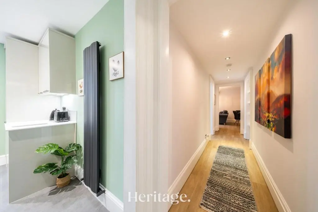 a hallway with green and white walls at The Copper Loft Apartment, Keith in Keith