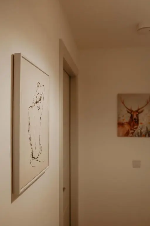 a drawing on a wall next to a picture on a wall at Luxurious Apartment in Inverness in Inverness