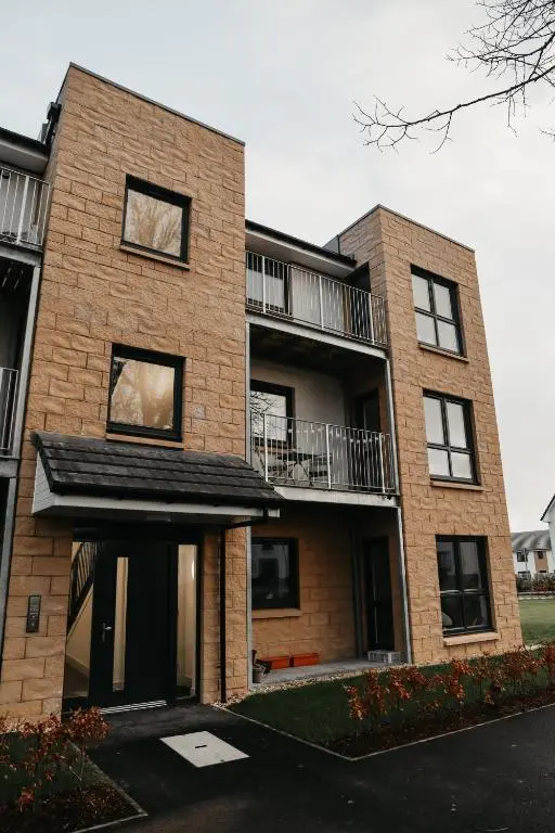 a brick apartment building with a balcony at Luxurious Apartment in Inverness in Inverness