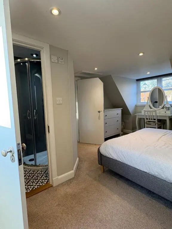 a bedroom with a bed and a walk in closet at Cosy Carnegie Cottage close to Dornoch Golf Course in Dornoch