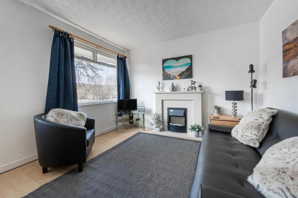 a living room with a couch and a fireplace at 2 Bed Chalet - Sleeps 4 - River and mountain views in Strathpeffer