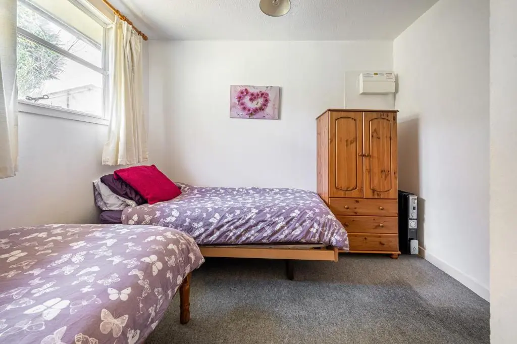 a bedroom with two beds and a dresser at 2 Bed Chalet - Sleeps 4 - River and mountain views in Strathpeffer