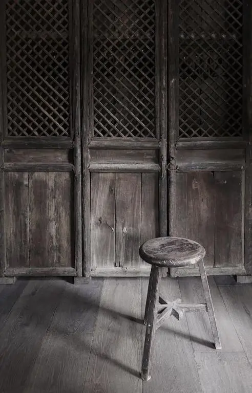 a stool sitting in front of a wooden cabinet at Luxury lodge for 16 in Royal Deeside in Ballater