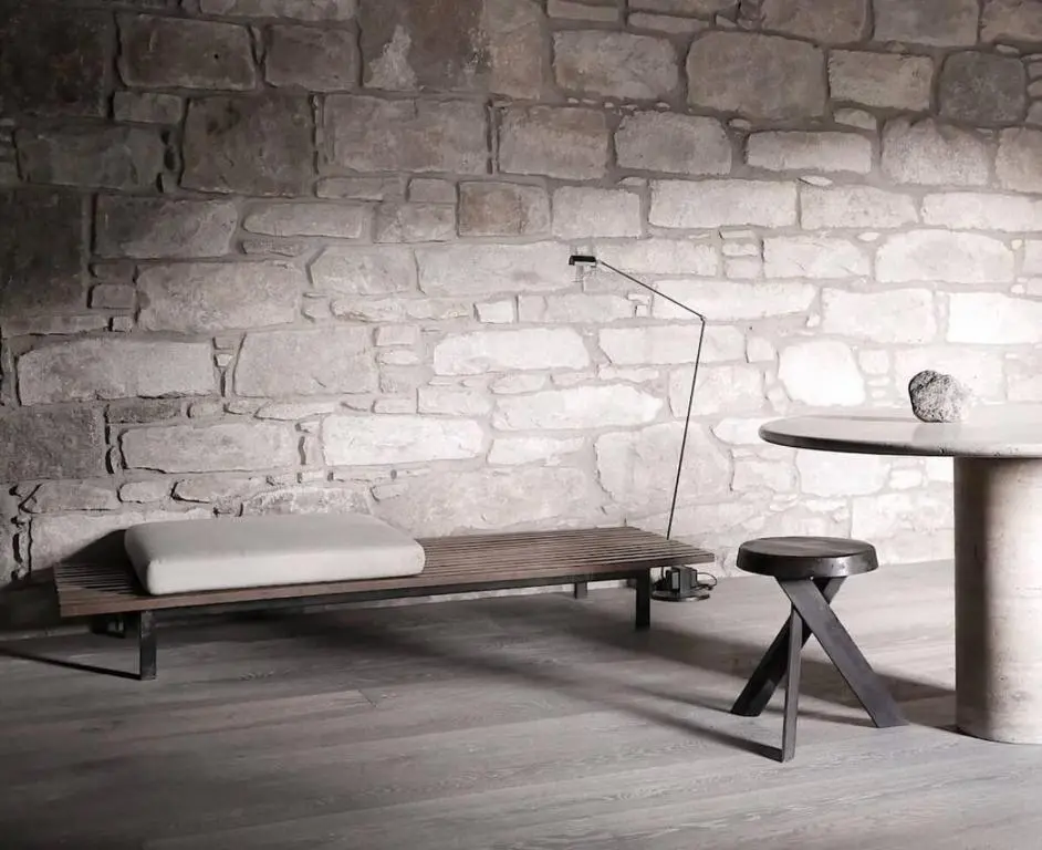 a bench and a table in a room with a brick wall at Luxury lodge for 16 in Royal Deeside in Ballater