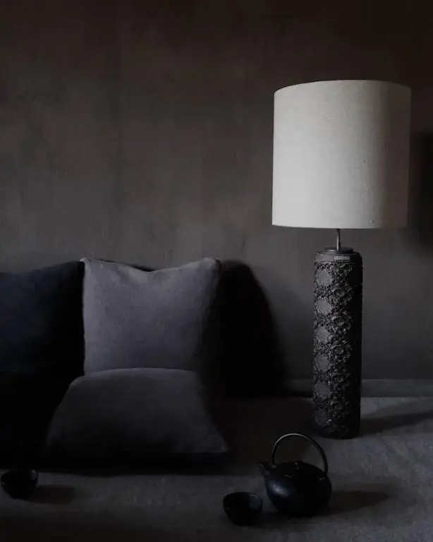 a lamp sitting on a table next to a couch at Luxury lodge for 16 in Royal Deeside in Ballater