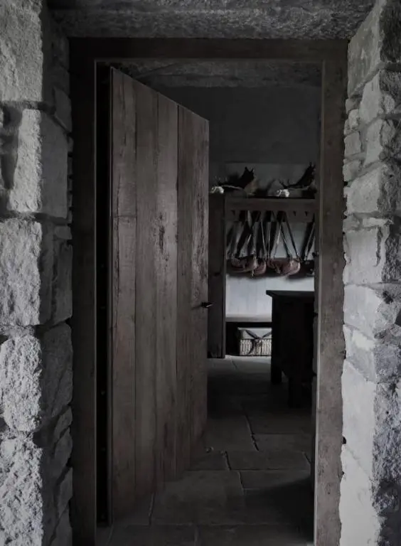 an open wooden door in a room with a table at Luxury lodge for 16 in Royal Deeside in Ballater
