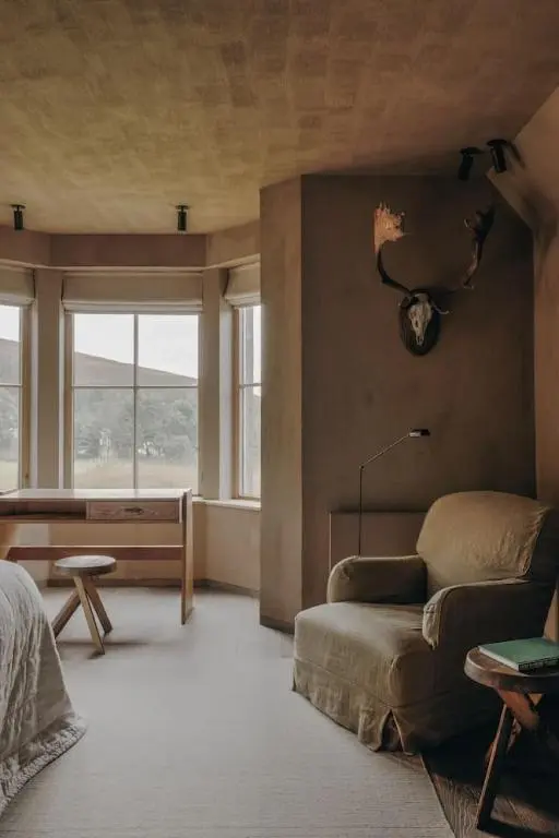 a living room with a couch and a bed at Luxury lodge for 16 in Royal Deeside in Ballater