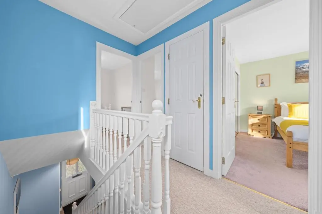 a bedroom with blue walls and a white staircase at Pinewood 3 Bedroom House in Inverness with Views in Inverness