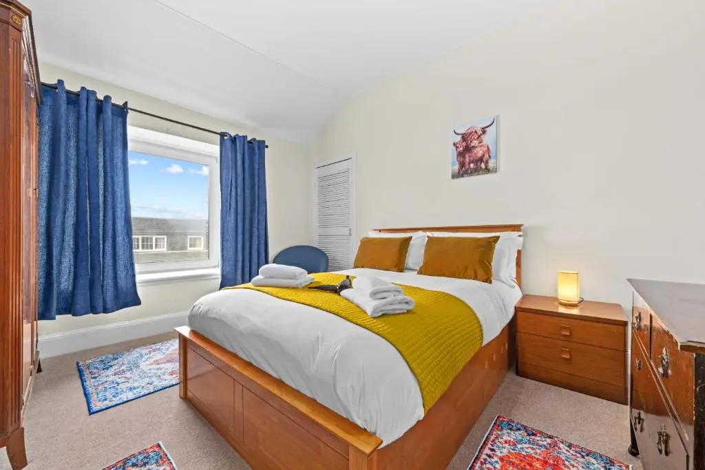 a bedroom with a large bed and a window at Central 1 Bedroom Apartment - Inverness in Inverness