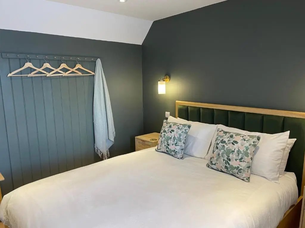 a bedroom with a white bed with two pillows at Struie Bothy near Dornoch Beach in Dornoch