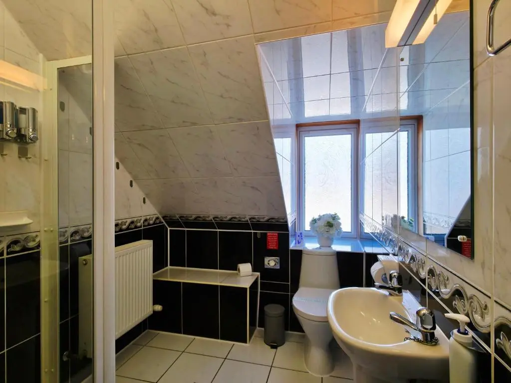 a bathroom with a sink and a toilet and a window at Inverness City 4 Bedroom house free parking in Inverness