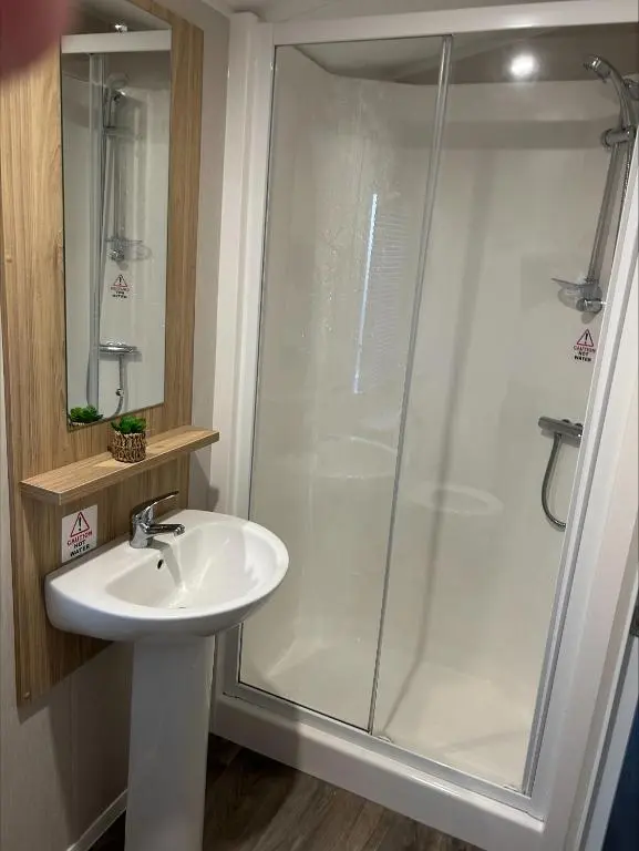 a bathroom with a shower and a sink at Silversands holiday park new caravan in Lossiemouth