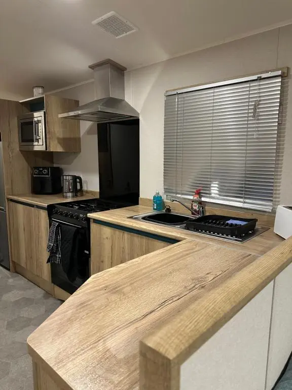 a kitchen with a stove and a counter top at Silver Dunes in Lossiemouth