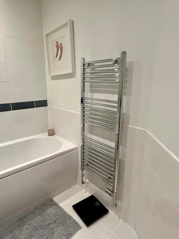 a white bathroom with a tub and a toilet at Luxury 2 bedroom apartment in Aberdeen in Kirkton of Skene