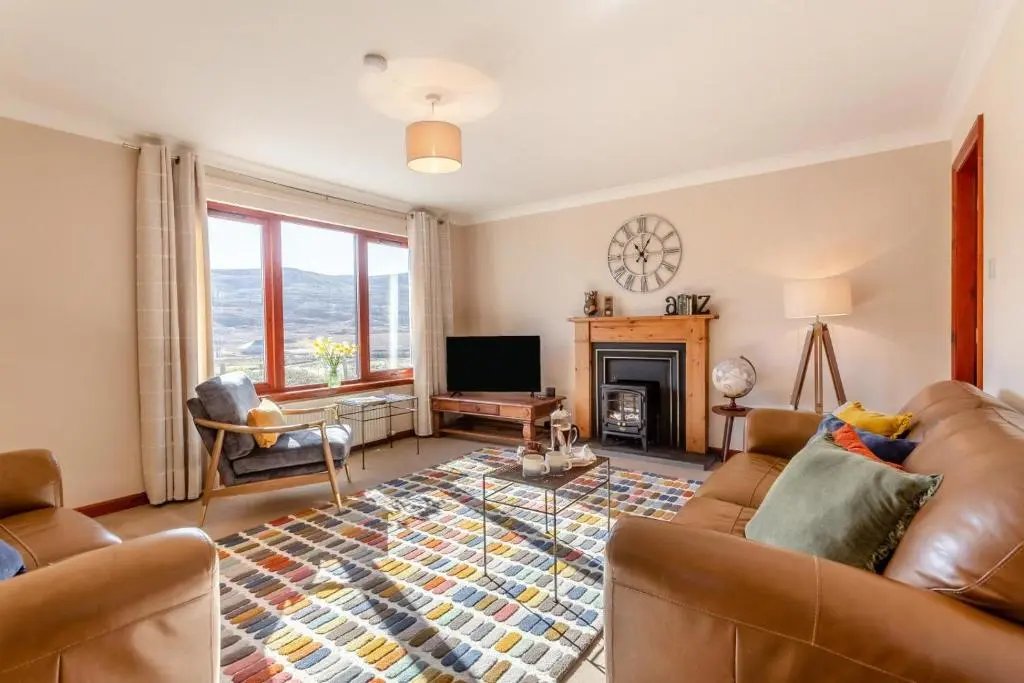 a living room with a couch and a fireplace at 3 Bed in Strathkanaird oc-r30948 in Ullapool