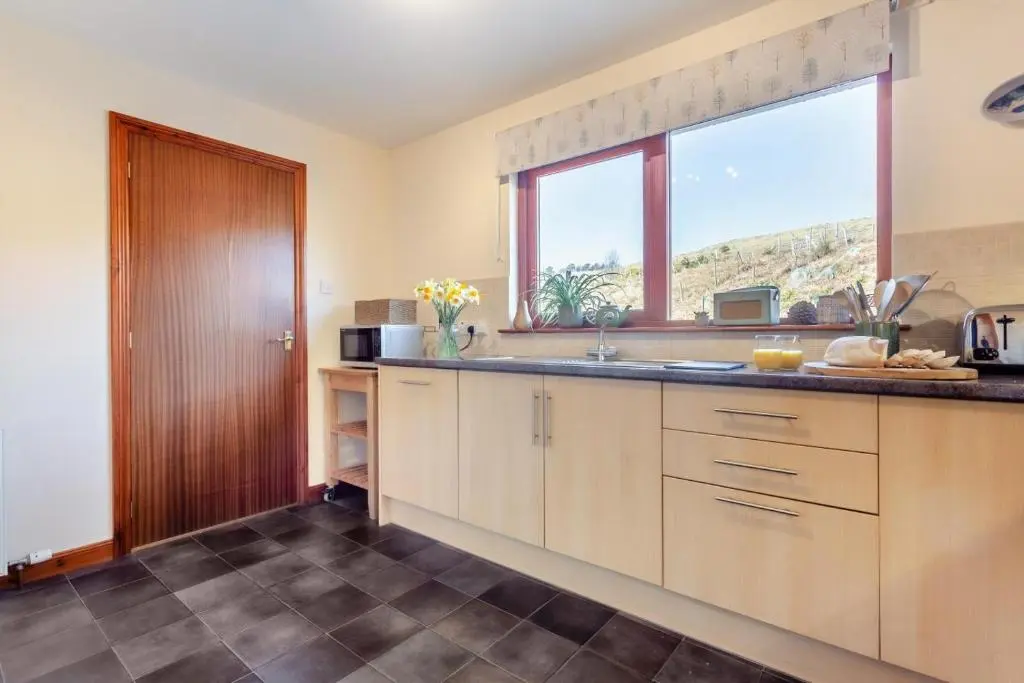 a kitchen with a sink and a window at 3 Bed in Strathkanaird oc-r30948 in Ullapool