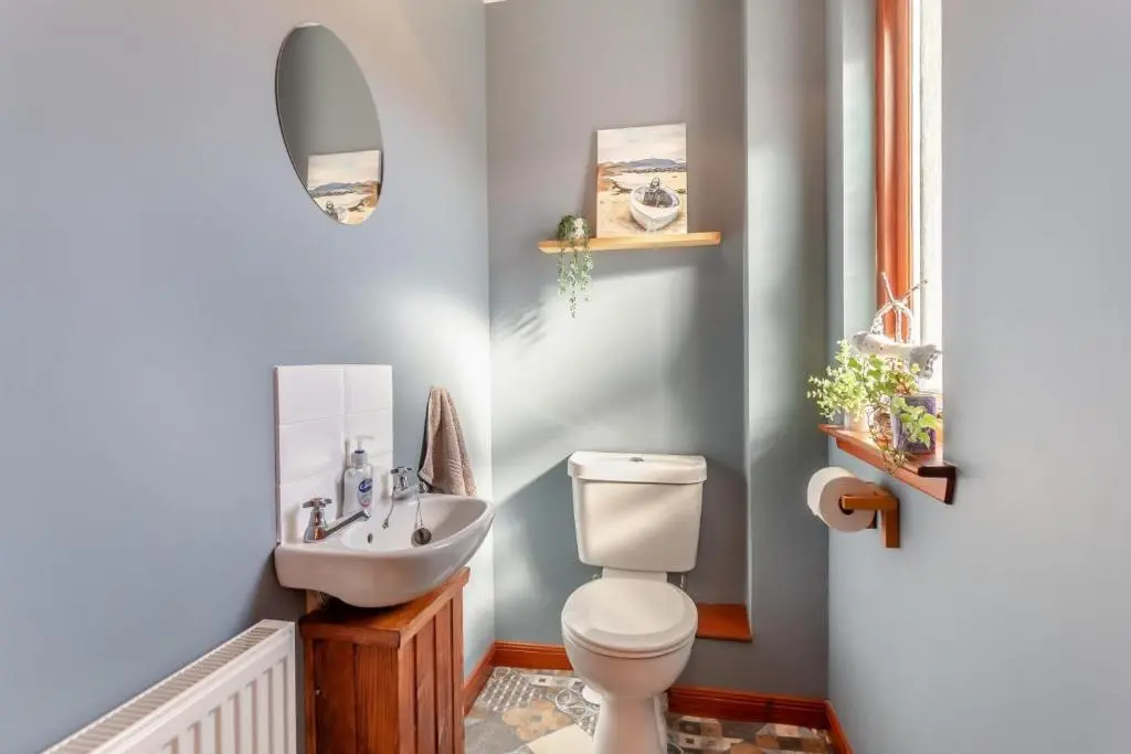 a bathroom with a toilet and a sink at 3 Bed in Strathkanaird oc-r30948 in Ullapool