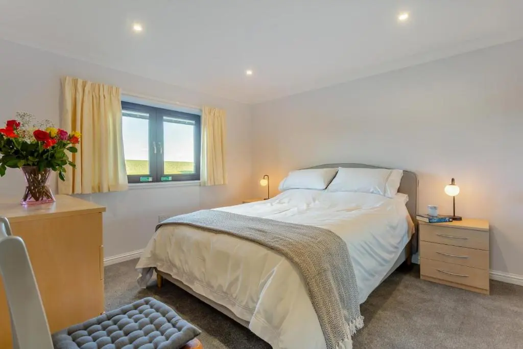 a bedroom with a bed and a vase of flowers at 2 Bed in Insch oc-t30986 in Colpy