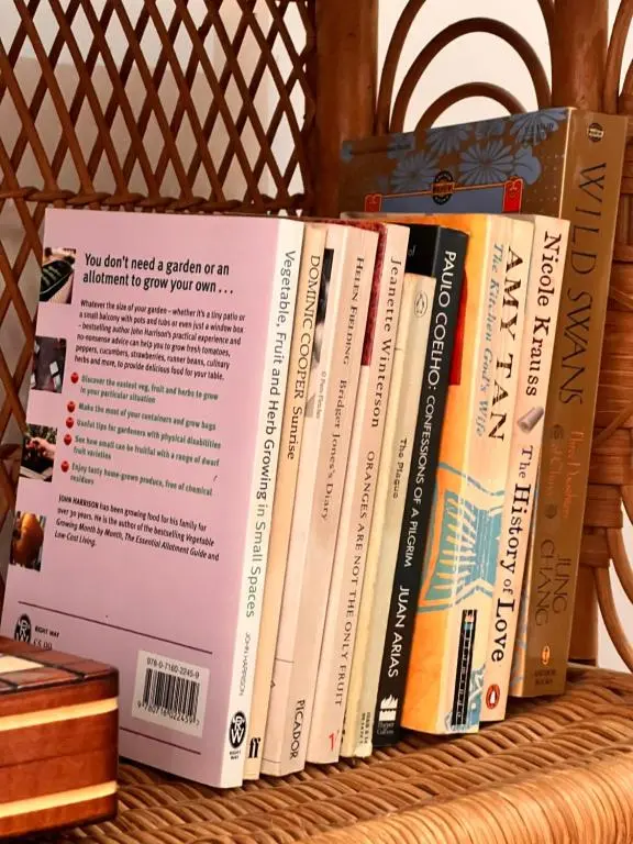 a row of books sitting on a shelf at The Space at the Creamery - Royal Deeside in Torphins