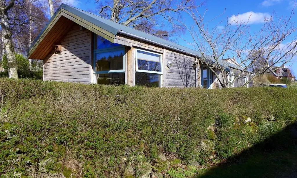 a small house on top of a grassy hill at The Space at the Creamery - Royal Deeside in Torphins