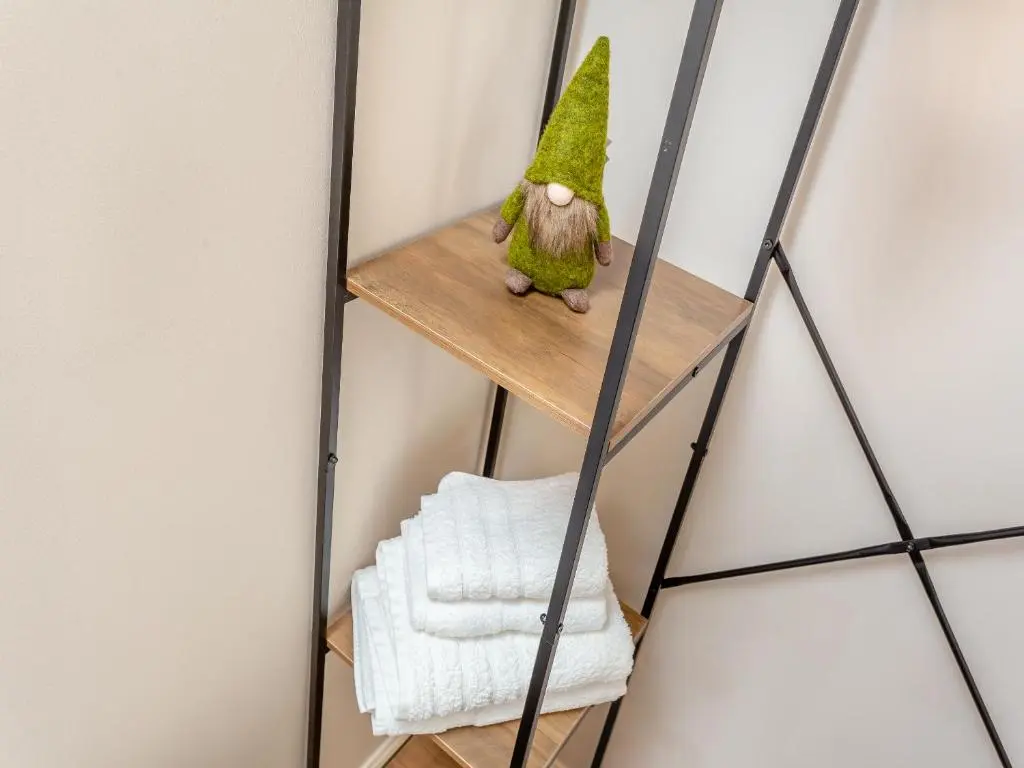 a ladder shelf in a room with a toy tree on it at Harbour View in Cromarty