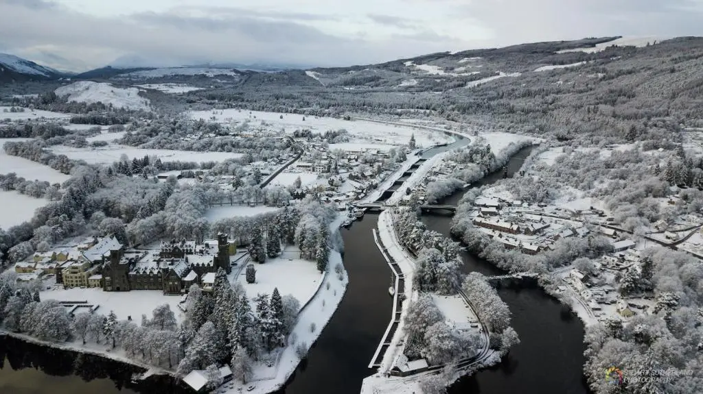 an aerial view of a town in the snow at Highland Club Scotland Apartments in Fort Augustus
