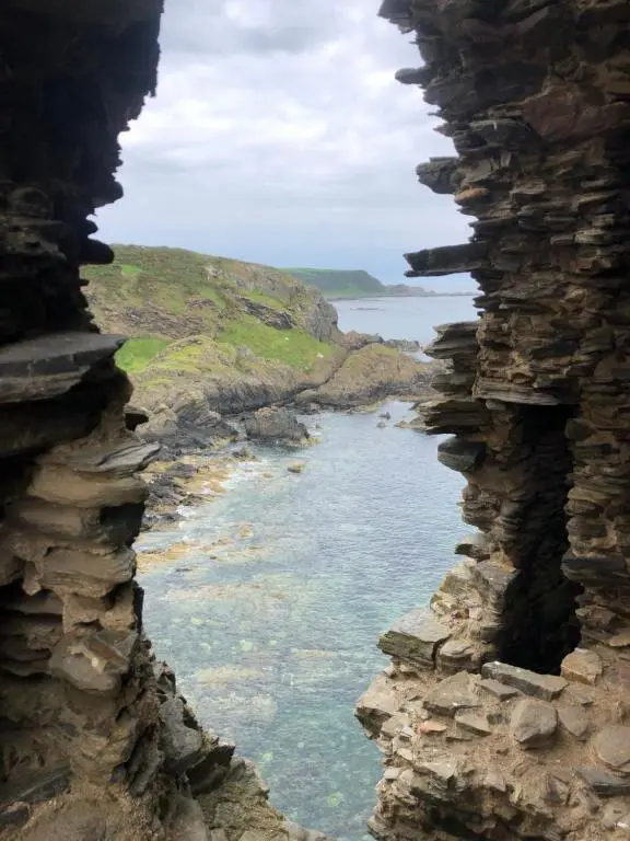 a view of the ocean through a window at Cozy Cottage Retreat in Portsoy