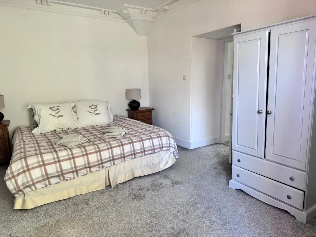 a white bedroom with a bed and a closet at 19th century 5-bedroom villa with free private parking in Elgin