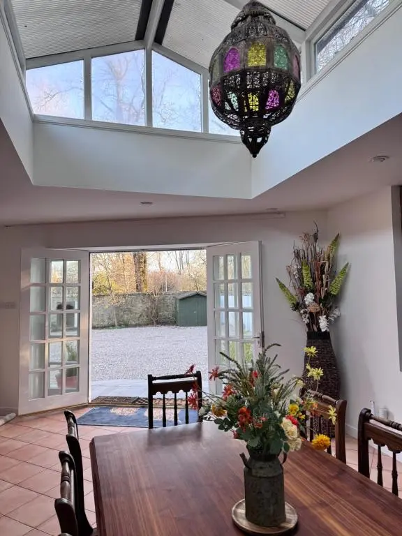 a dining room with a table and a chandelier at 19th century 5-bedroom villa with free private parking in Elgin