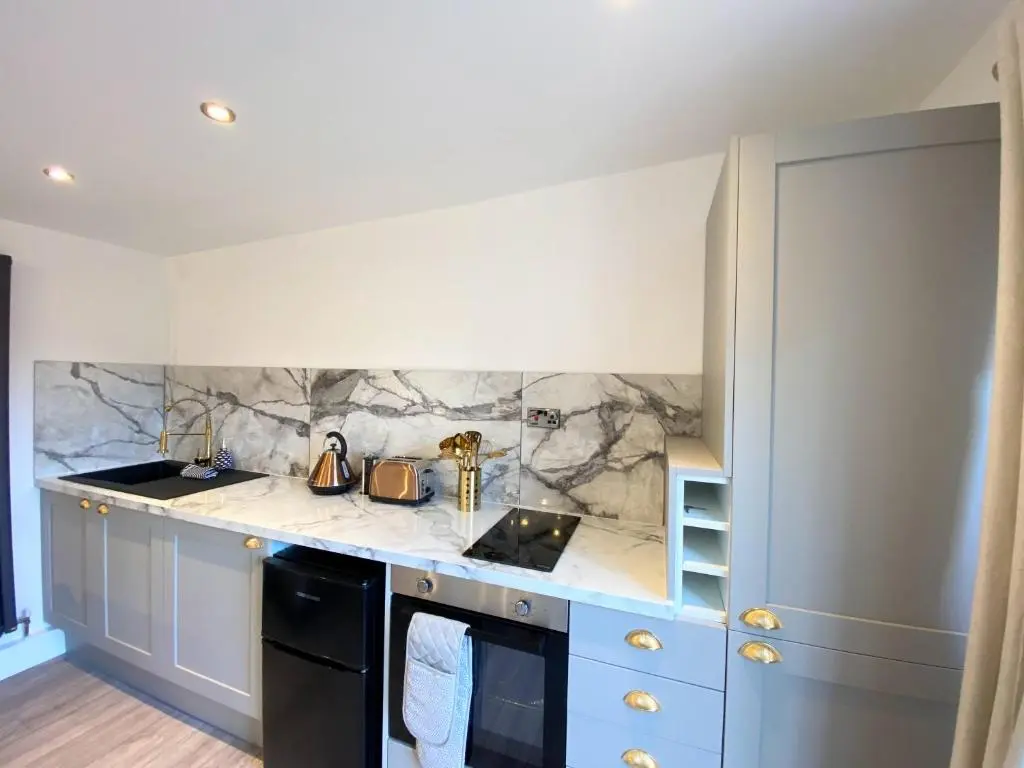 a kitchen with a sink and a counter top at Kaoglen - Bali Pod - Hot Tub -Cairngorms - Pitlochry in Kirkmichael