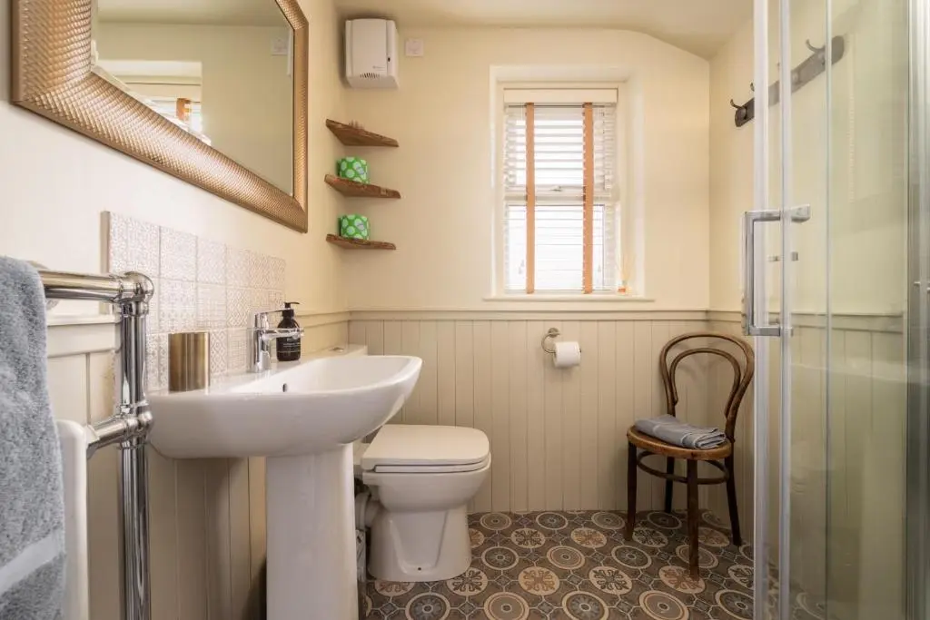 a bathroom with a sink and a toilet and a shower at Duffus House Lodge in Duffus