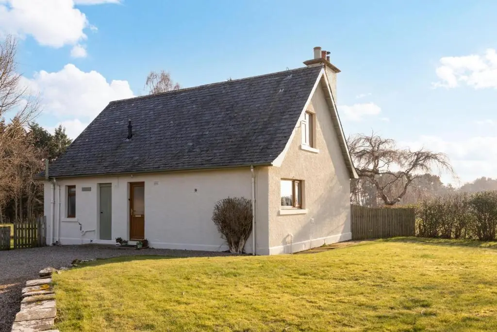 a white house with a black roof at Kirktoun Cottage in Duffus